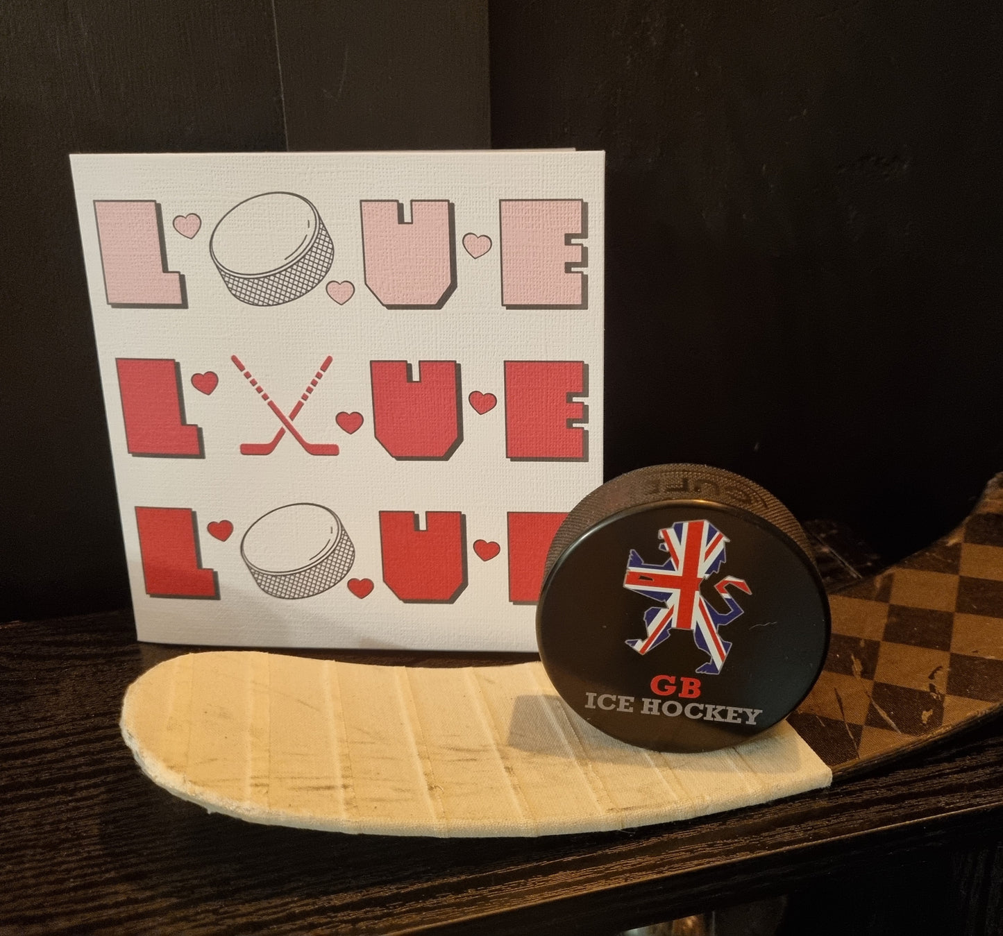 Ice hockey card made with letters spelling love o is the puck