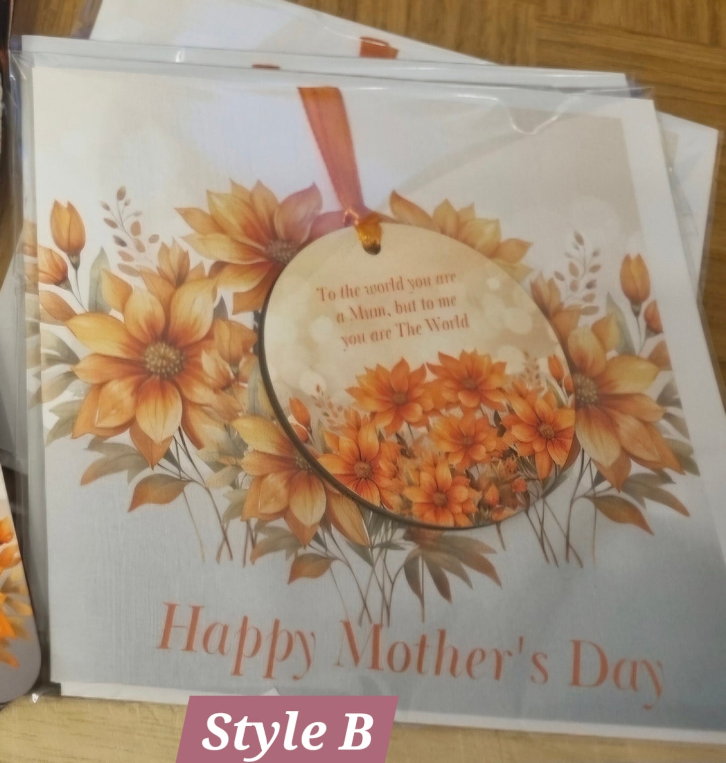 A square linen cardstock greeting card with a floral design and tassels, featuring a personalized message 'Happy Birthday Sandra'.