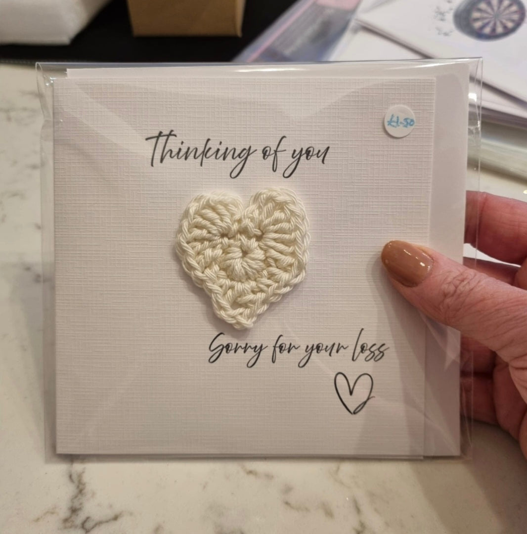 A square linen cardstock greeting card with a floral design and tassels, featuring a personalized message 'Happy Birthday Sandra'.